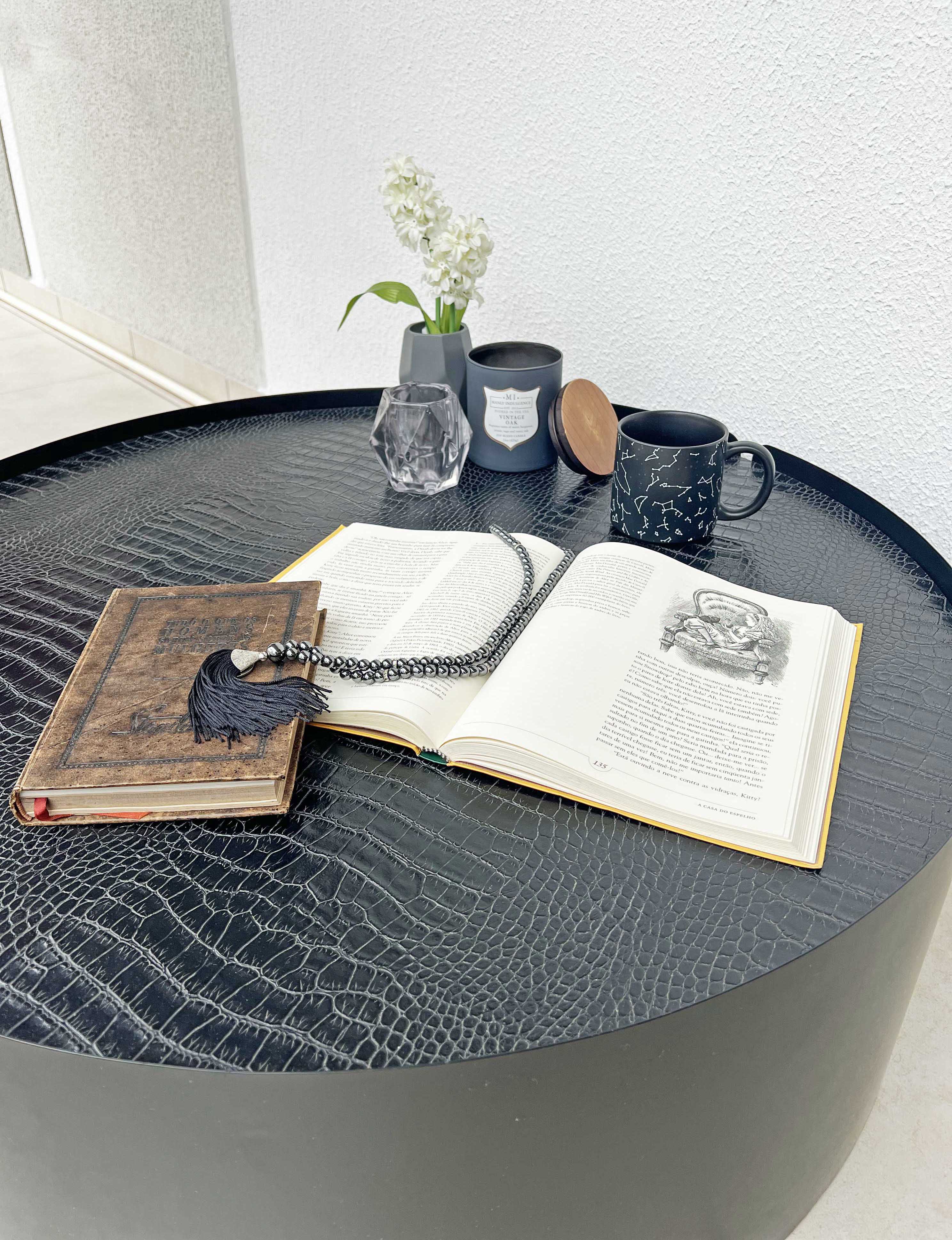 Mesa de centro redonda preta assinada pelo designer Marcelo Ligieri 