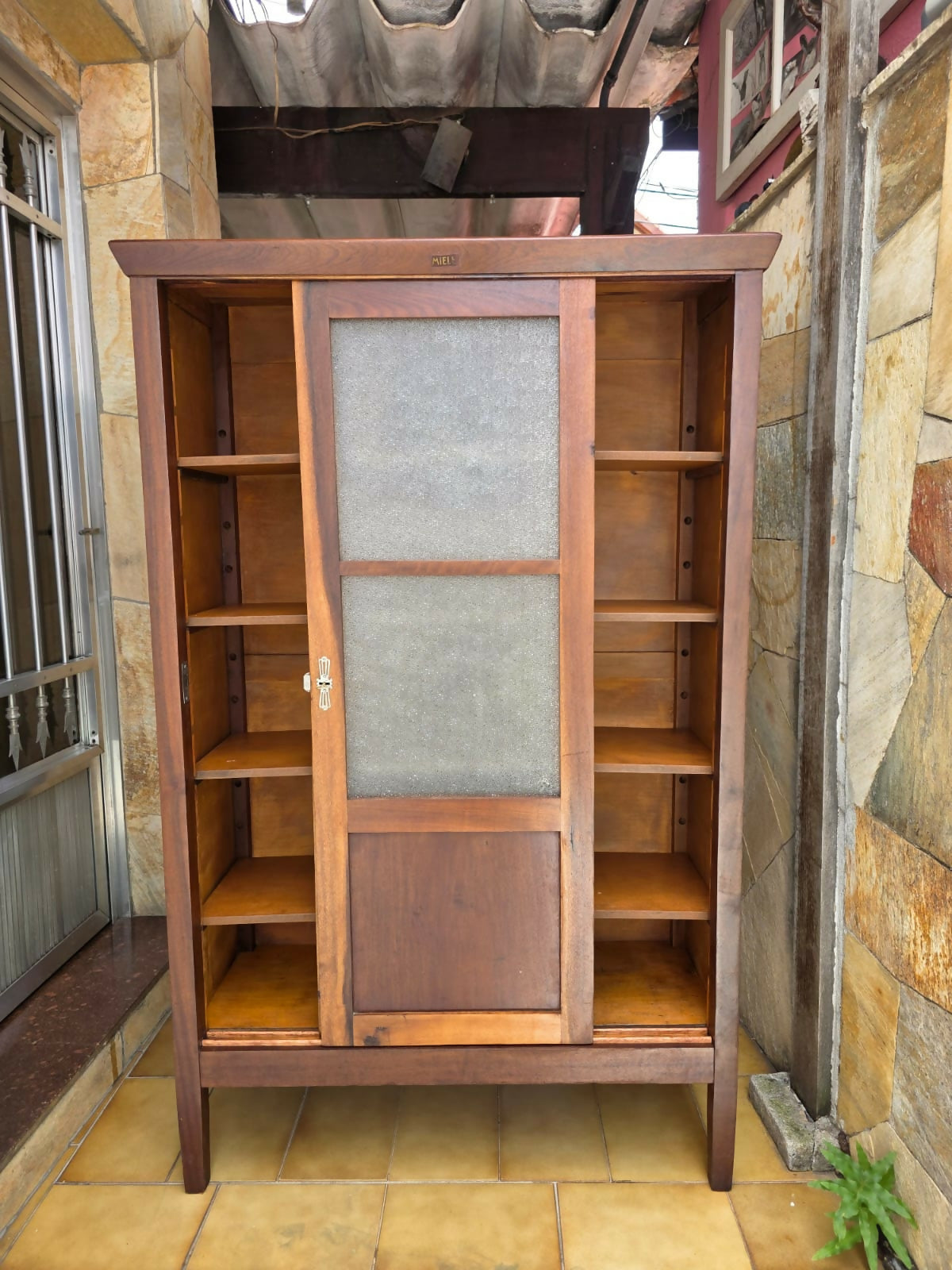 Armário / Livreiro Miele portas de correr, década de 60, possui 4 tábuas, selos da época, chave e fechadura.