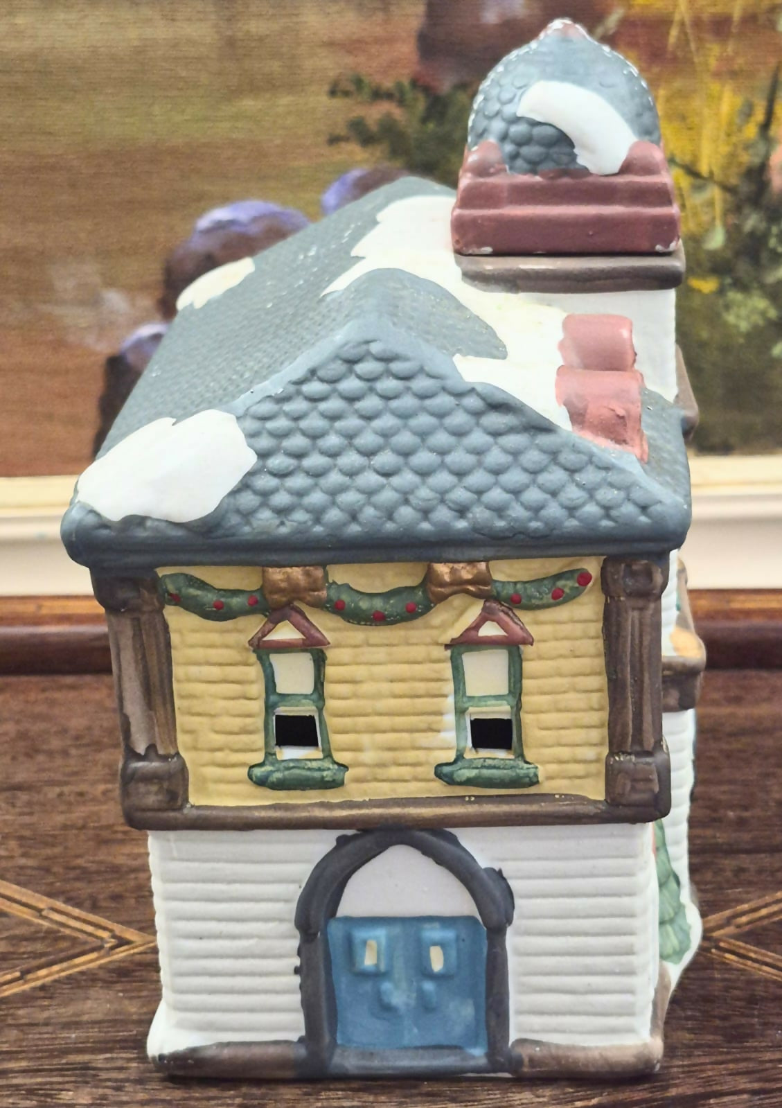 Casinha luminária representando estação de trem vintage, feita em biscuit, com portas, janelas e relógio frontal vazados para iluminação interna.