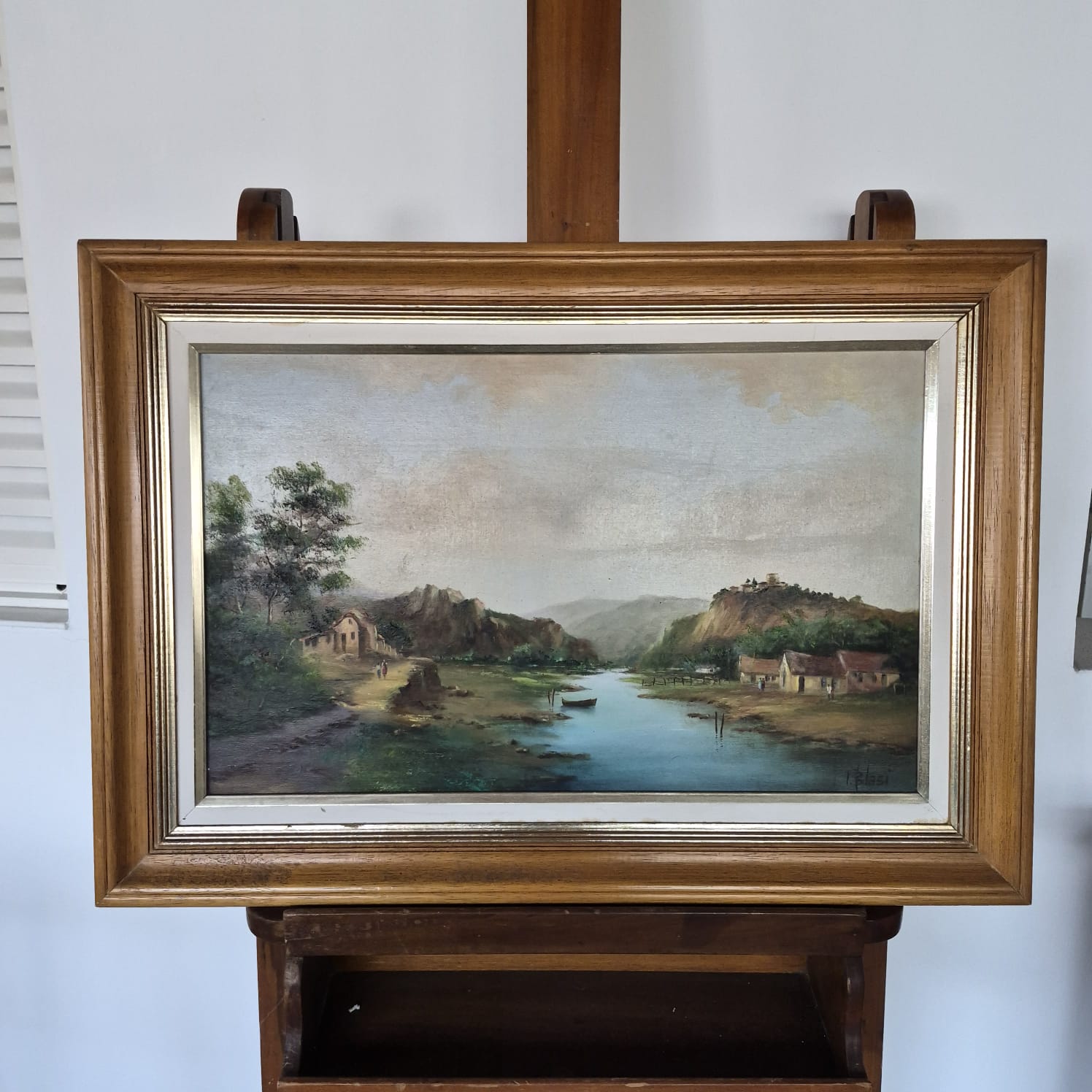 Quadro, pintura, óleo sobre tela, representando paisagem lacustre e casario, assinado frente e verso por Ivo Blasi.