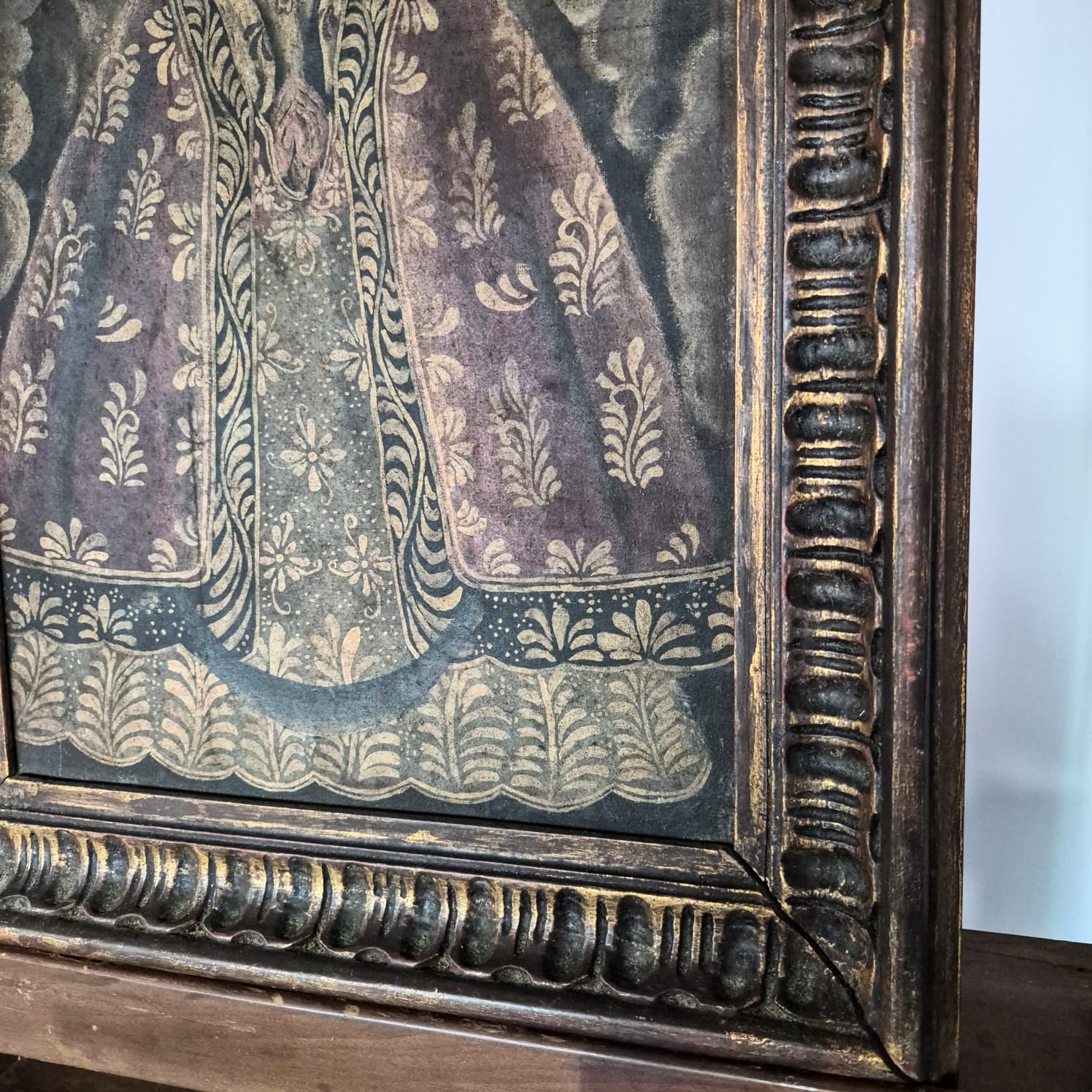  Quadro com pintura,  óleo sobre tela,  sacra antiga de Nossa Senhora, de Escola Cusquenha, caracterizada por traços coloniais, mantos ricamente ornamentados.