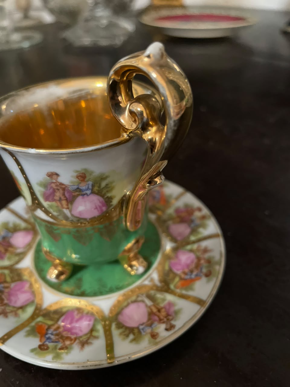 Xícara com pires em porcelana com cena galante e douração Bavária