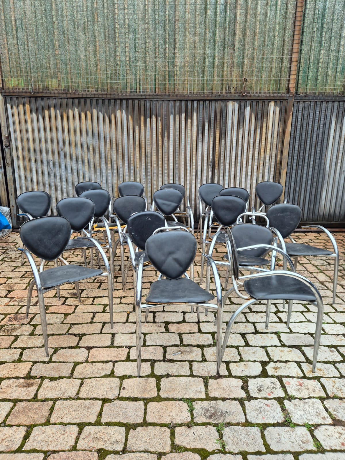 Cadeiras de Design Italiano com linhas curvas em metal tubular e assento preto 